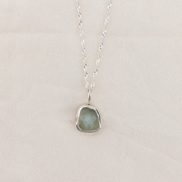 Necklace with a pendant on a light gray background