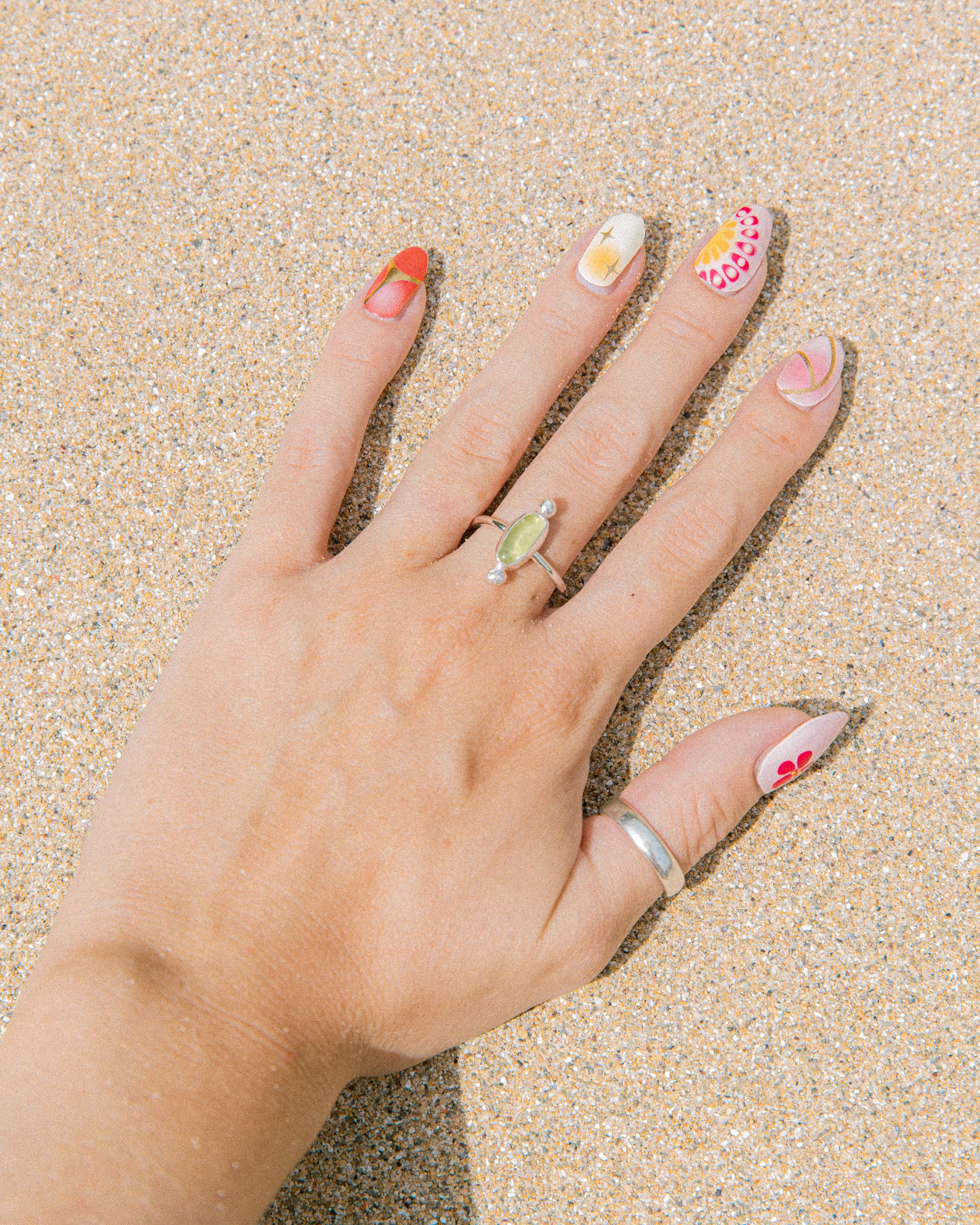 Lime yellow sea glass ring worn on hand, handmade sterling silver, Broken Wave Jewellery Newquay