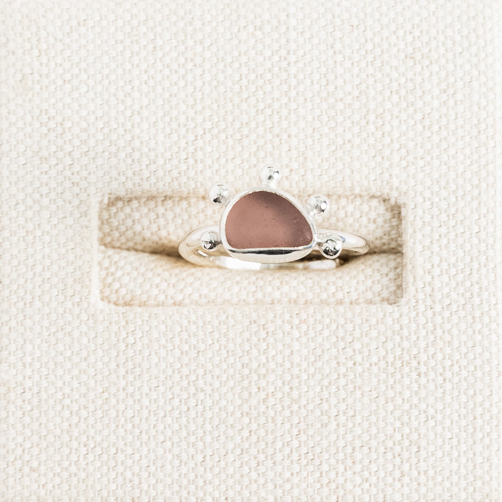 Rare pink sea glass ring with handmade sterling silver sunburst setting by Broken Wave Jewellery Cornwall
