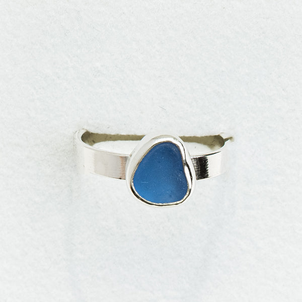 Silver ring with a blue stone on a white background