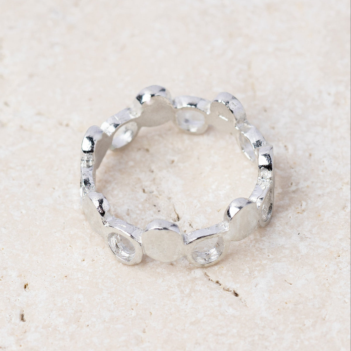 Pebble ring in recycled sterling silver, a band of hand shaped silver pebbles, handmade in Cornwall