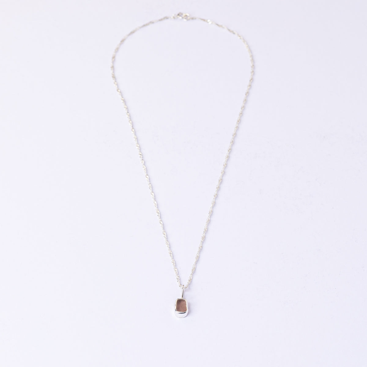 Full length of the pink sea glass necklace on its sterling silver chain