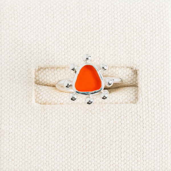 Rare orange sea glass ring with handmade sterling silver sunburst setting by Broken Wave Jewellery Cornwall
